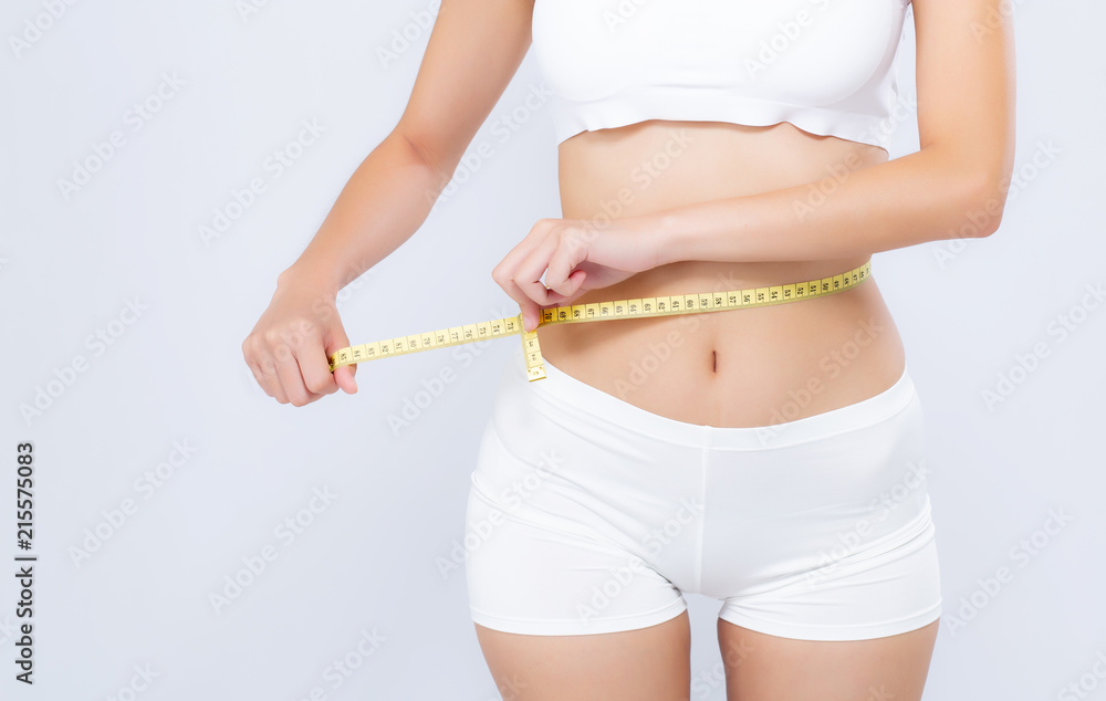 Asian woman diet and slim with measuring waist for weight isolated on white background, girl have cellulite and calories loss with tape measure, health and wellness concept. - obrazy, fototapety, plakaty 