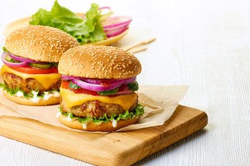 Wall Mural - Two burgers on cutting board