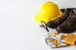 © ronnarong - Construction site safety. Personal protective equipment on white background. Free space for text