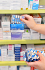 Wall Mural - Pharmacist holding medicine capsule pack at the pharmacy drugstore