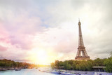Fototapeta Boho - Romantic sunset background. Eiffel Tower with boats on Seine river in Paris, France.