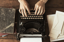 Young Man's Hands Typing On An Antique Vintage Typewriter