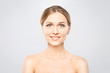© denis_vermenko - Portrait of young beautiful woman smiling while taking some facial cream isolated on white background with copy space.