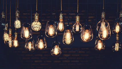 beautiful vintage luxury light bulb hanging decor glowing in dark. retro filter effect style.