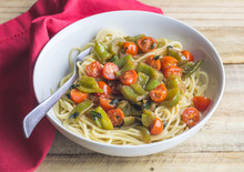 Vegan Pasta - Cherry Tomatoes, Green Pepper And Basil On Spaghetti Close Up