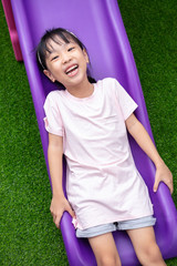 Wall Mural - Asian Chinese Little Girl Playing on the slide