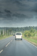 © Mak - Delivery white van on the rural road under the dark clouds