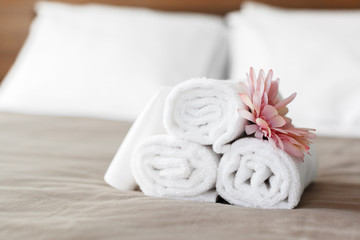 Sticker - towels and flower on bed in hotel room