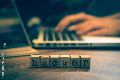 Fotografie, Obraz Word Hacker with hands working on notebook.