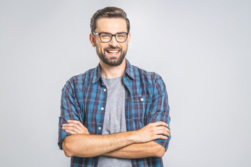 happy young man. portrait of handsome young man in casual shirt keeping arms crossed and smiling whi