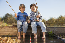 Happy Boys Go Fishing On The River, Two Children Of The Fisher With A Fishing Rod On The Shore Of Lake