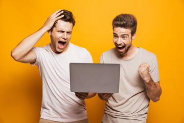 Wall Mural - Portrait of a two excited young men best friends