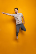 © Drobot Dean - Full length portrait of a happy young man jumping