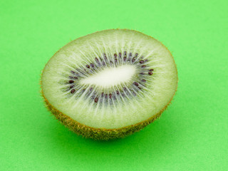 Wall Mural - Slices kiwi fruit on green background