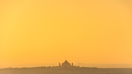 A silhouette of Umaid Bhawan Palace, the one of the world's largest private residences with a golden sunrise sky from Jodhpur the Blue City, Cantt Area, Jodhpur, Rajasthan