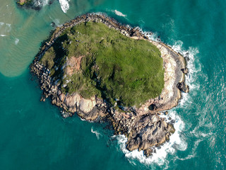 Wall Mural -  Aerial view (90 degrees) of isolated green island in Brazilian green sea.