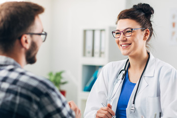 Wall Mural - Doctor at her Medical Office with Patient