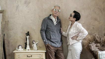 Happy Asian senior couple casual dress with sunglasses in vintage house