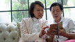 Daugther teaching mother to use smart phone for social media at home