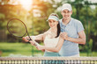 © VadimGuzhva - Happy Couple Standing on Tennis Court with Rackets