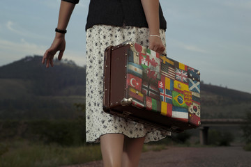 Woman with vintage travel suitcase