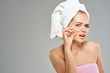© SHOTPRIME STUDIO - woman with a towel on her head squeezes out acne
