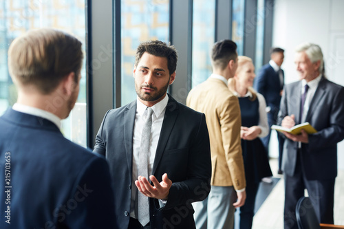 Confident handsome mixed race businessman with beard sharing his opinion with fo Canvas Print