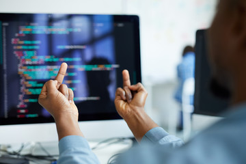 Wall Mural - Close-up of unrecognizable African man flipping desktop computer with error off and showing fuck off gestures