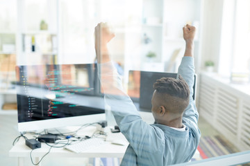 Sticker - ecstatic young african-american software developer raising hands in excitement while achieving succe