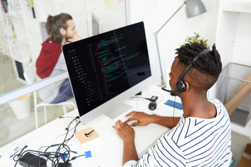 Wall Mural - serious busy african-american it engineer in hands free device solving problem remotely and working 