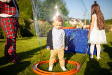Child Inside The Soap Bubble. Bubbles Show, Entertainment For Kid's Birthday Party.