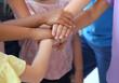 © New Africa - Little children putting their hands together, indoors. Unity concept