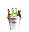 Bottles with different types of beer and ice in metal bucket on white background