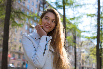 Wall Mural - Beautiful young blonde woman calling by phone