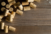 Heap Of Unused, New, Brown Natural Wine Corks On Wooden Board, Flat Lay Top View