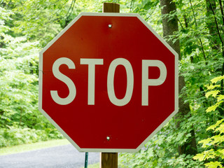 Stop sign and green forest