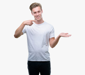 Sticker - Young handsome blond man very happy pointing with hand and finger