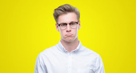 Canvas Print - Young handsome blond man depressed and worry for distress, crying angry and afraid. Sad expression.