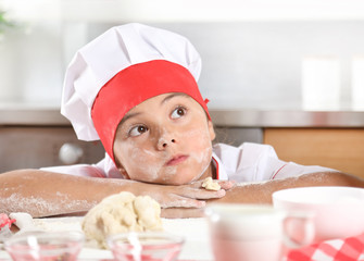 Portrait of a lovely little girl in a cook's suit