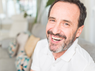 Handsome middle age man with a happy face standing and smiling with a confident smile showing teeth