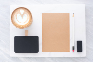 Wall Mural - Top view of Clip blackboard, pencil, eraser notepad and coffee cup on white marble block and stack on grey marble table.Flat lay Mock up template for adding or display text or design.Stationery item.