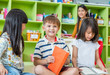 © weedezign - Children sitting on floor and reading tale book  in preschool library with teacher,Kindergarten school education concept.