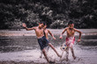 © Panya Studio - Boys play football on a muddy waters