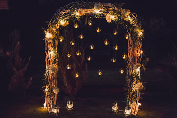 Wall Mural - Night wedding ceremony, arch on party decorated with lights and candles in round glass spheres