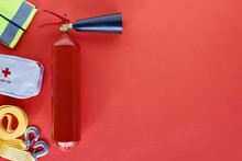 Top View Of Fire Extinguisher And Automotive Accessories On Red Backdrop