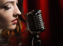 Portrait Of Beautiful Woman Singing In Microphone