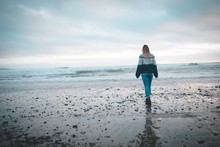 Woman Walking On A Beach