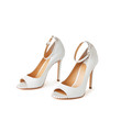 © monchak - Elegant white open toe pumps shoes with metal dots. Studio shot, white background.