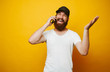© Vulp - Cheerful man with beard talking on phone