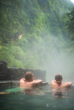 Friends Chatting In The Warm Waters Of Jhinu Hot Springs In The Annapurna, Himalaya, Nepal.